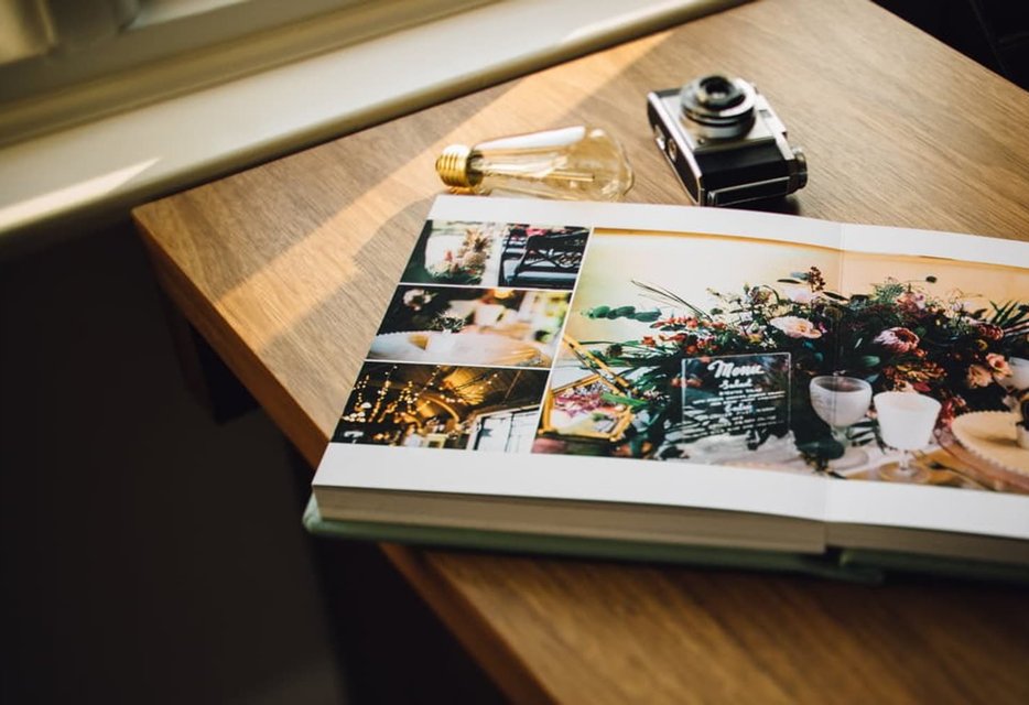 Open wedding album showing beautiful photographs from the day