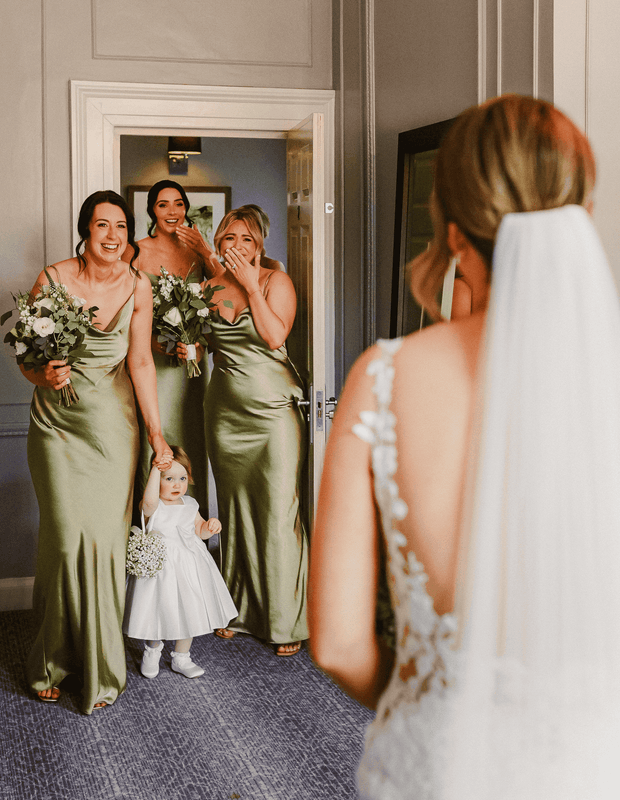 Bride showing dress to bridesmaids