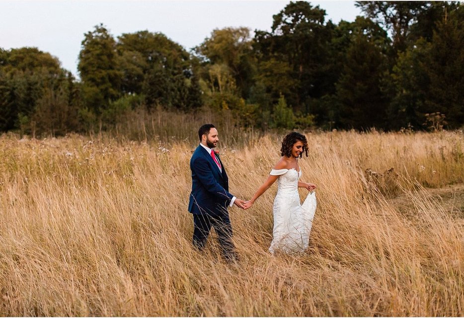 Bride and groom in the grounds of Great Fosters mansion