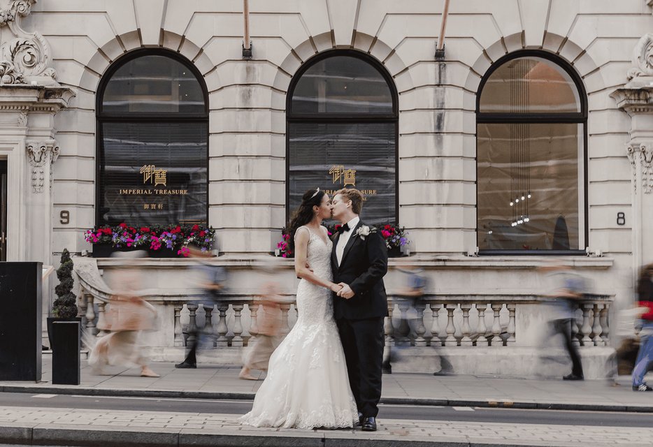 Bride and groom on the steps of St James' Church Piccadilly