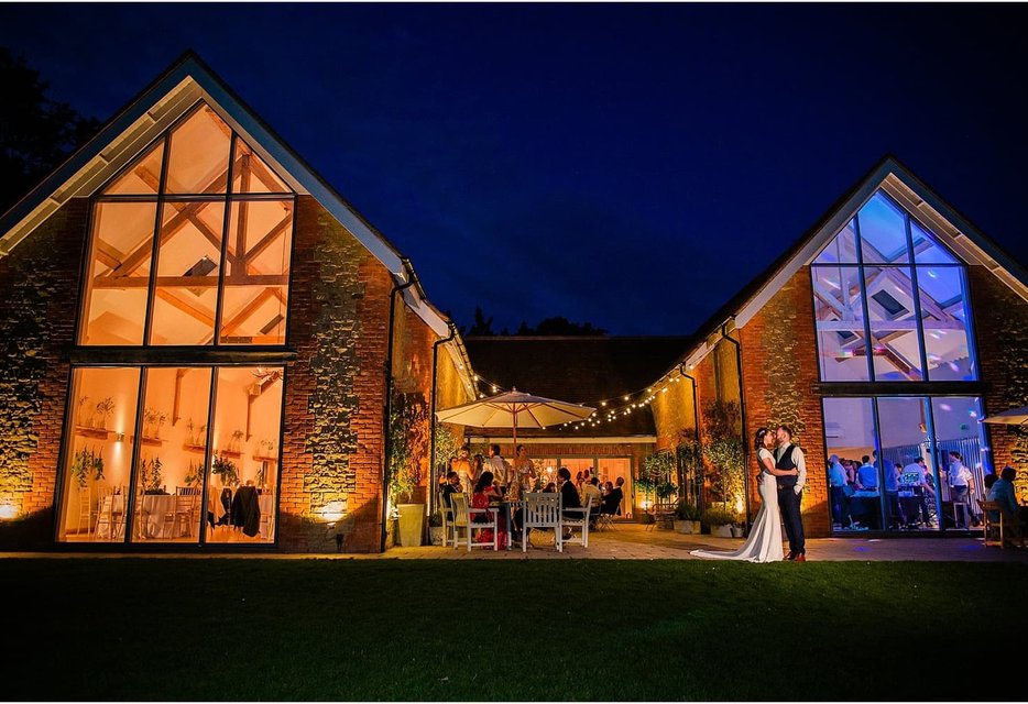 Bride and groom in golden sunset light at Millbridge Court