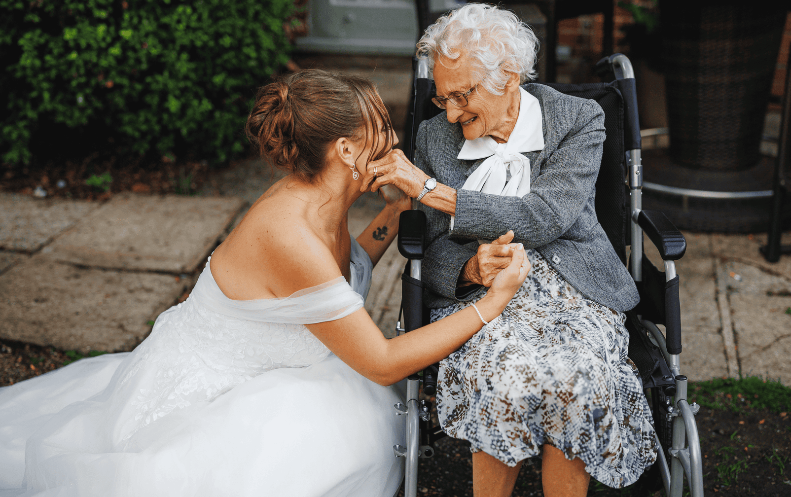 Lady in wedding dress with senior lady