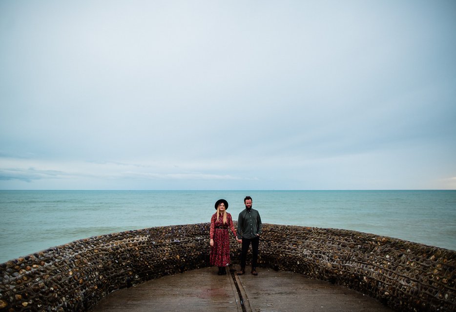 Couple in coordinated casual outfits during engagement photo session