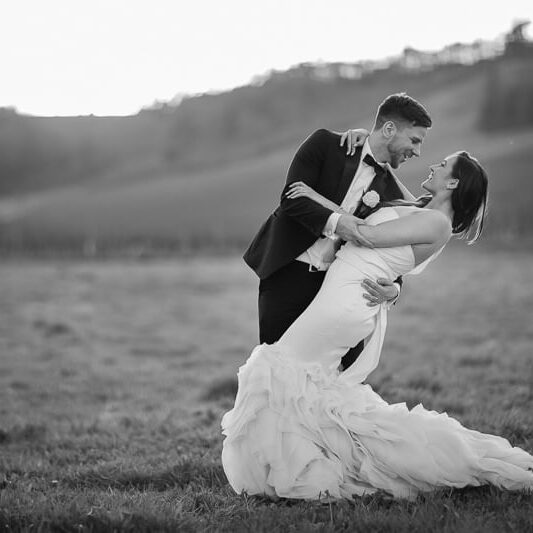 Groom in classic black tuxedo with bow tie at formal wedding