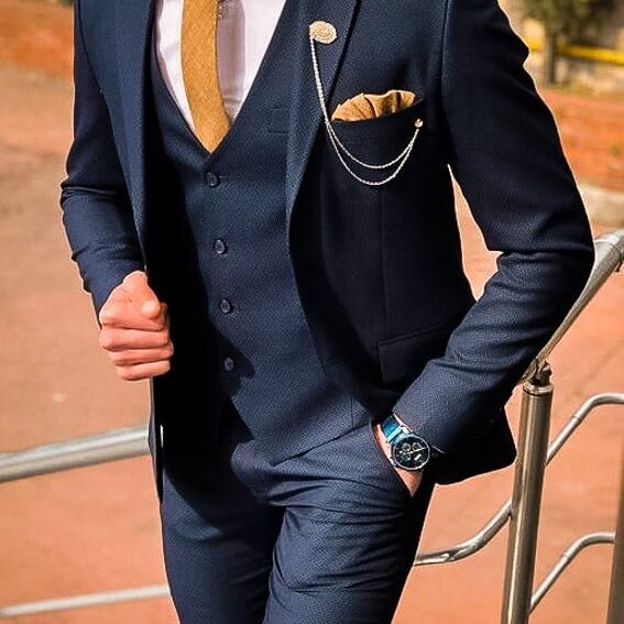 Navy three-piece suit with patterned waistcoat and tie