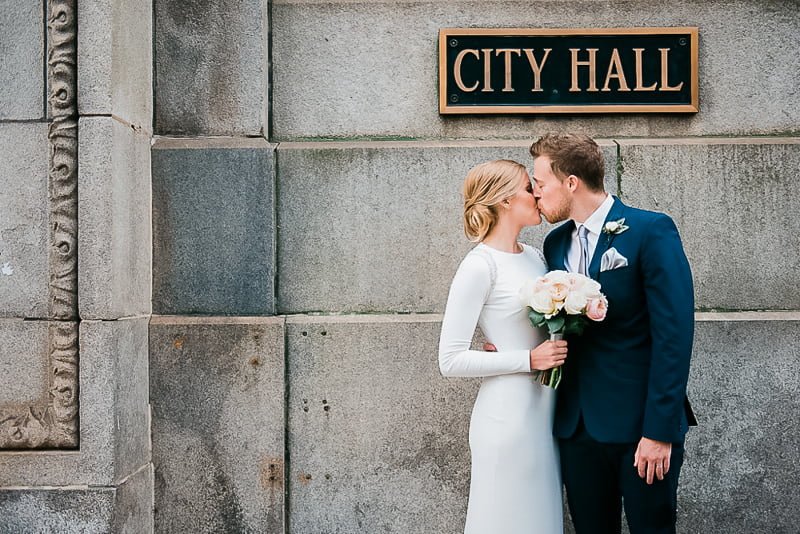 Groom in modern navy suit at urban boutique hotel wedding