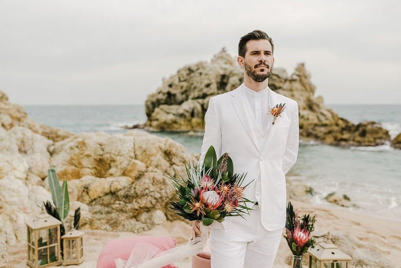 White linen suit at outdoor beach ceremony