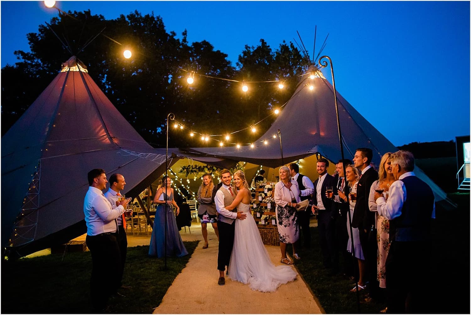 Evening reception under festoon lights in the garden