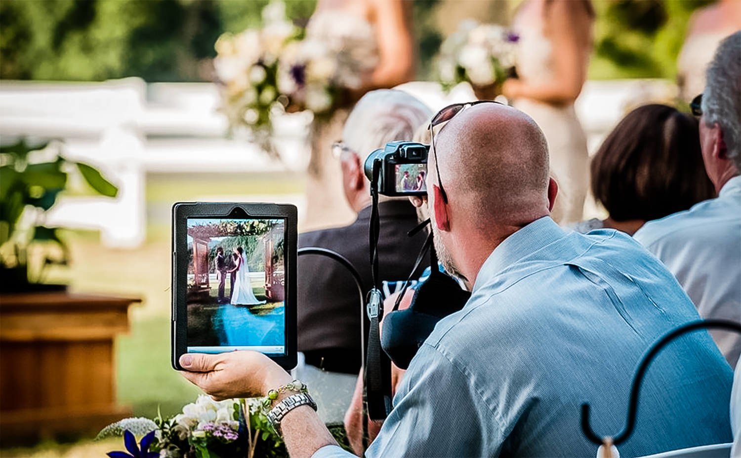 Wedding guests watching ceremony without phones, fully present in the moment